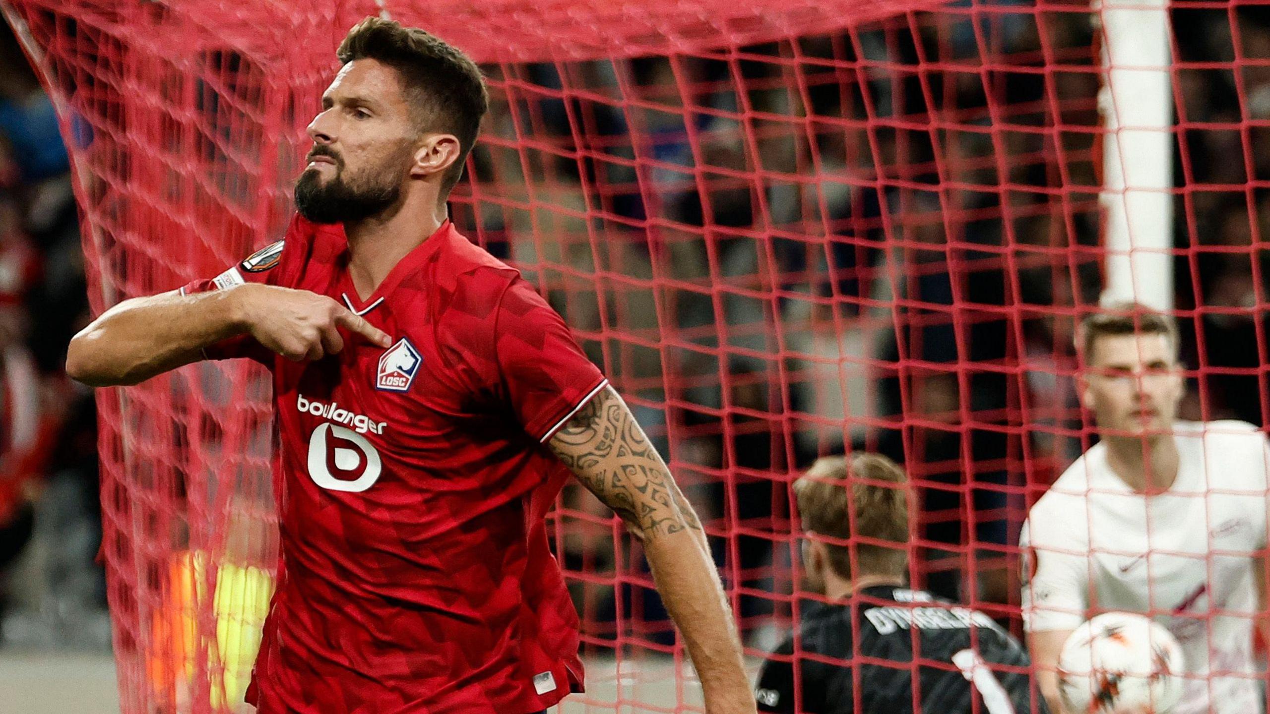 Olivier Giroud points to the club badge as he celebrates scoring for Lille against Brann