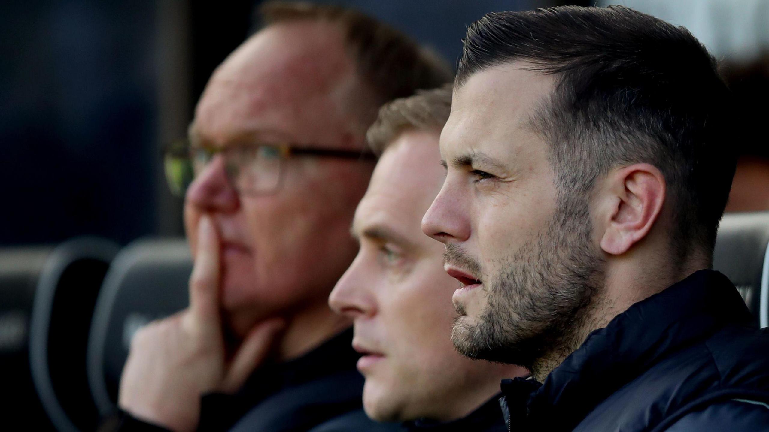 Jack Whilshire pictured nearest to the camera on the right, sitting next to Johannes Thorup. Both men are looking to the left and away from the camera.