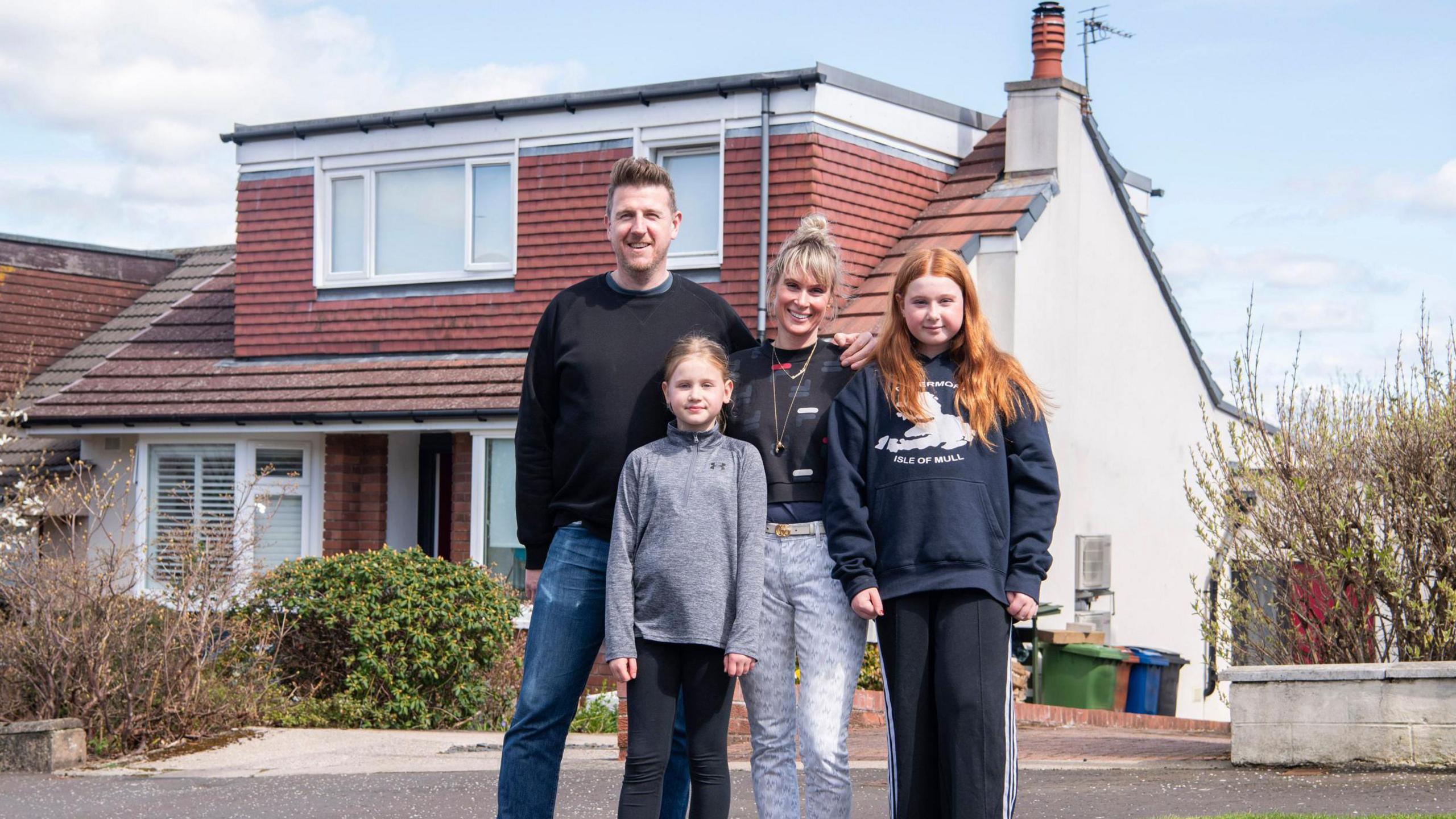 Harry, Anna and their children Marley and Lexie outside the 1960s Bungalow, Milngavie