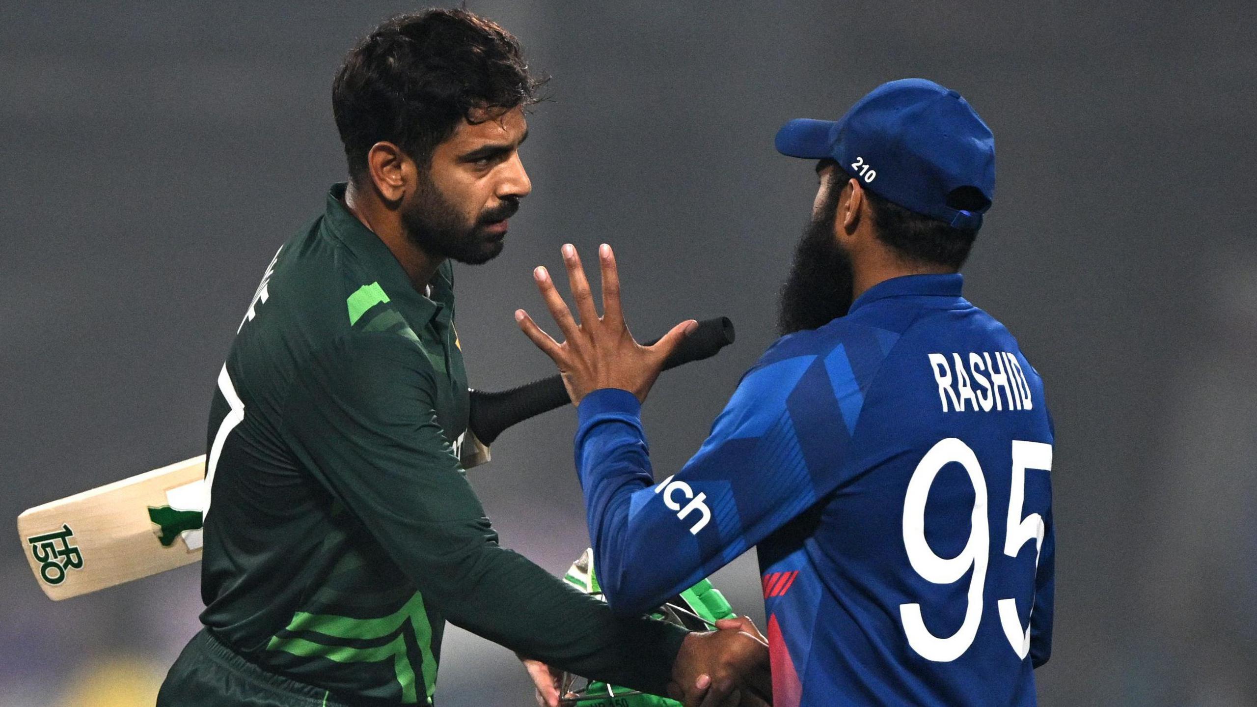 Pakistan's Haris Rauf shakes hands with England's Adil Rashid at the 2023 World Cup