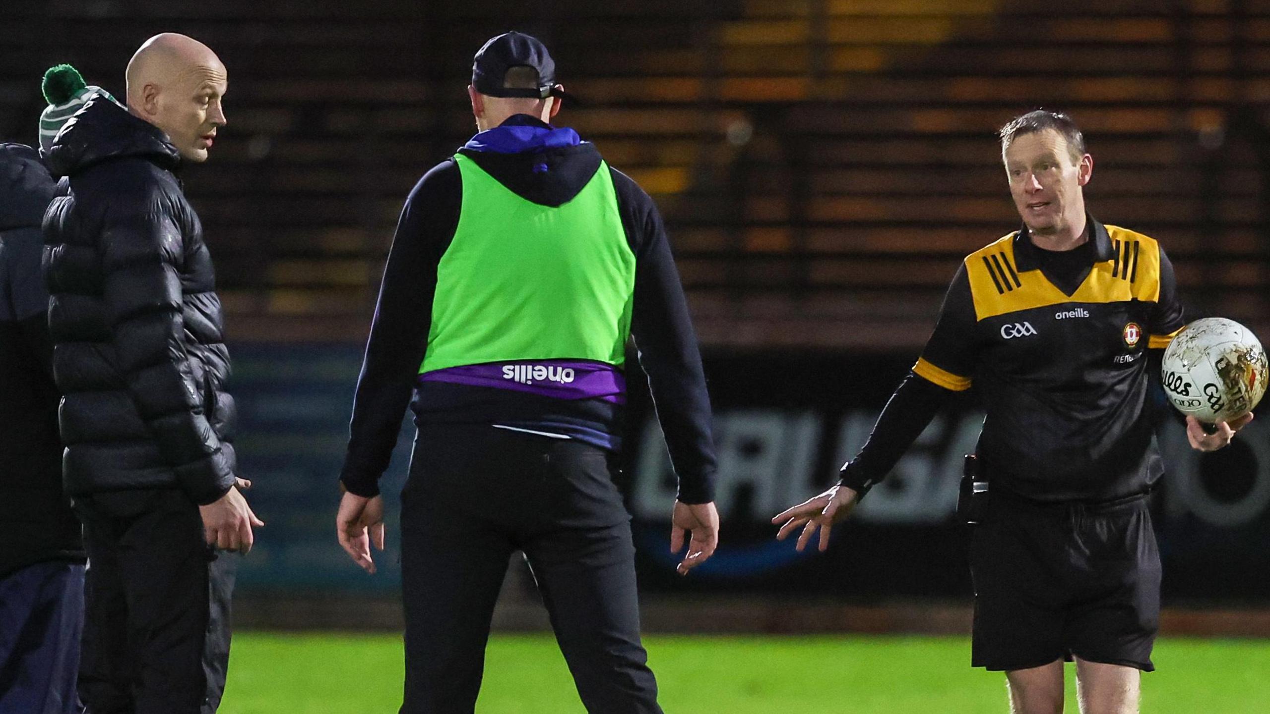 Both managers and referee Joe McQuillan during the half time pitch inspection 