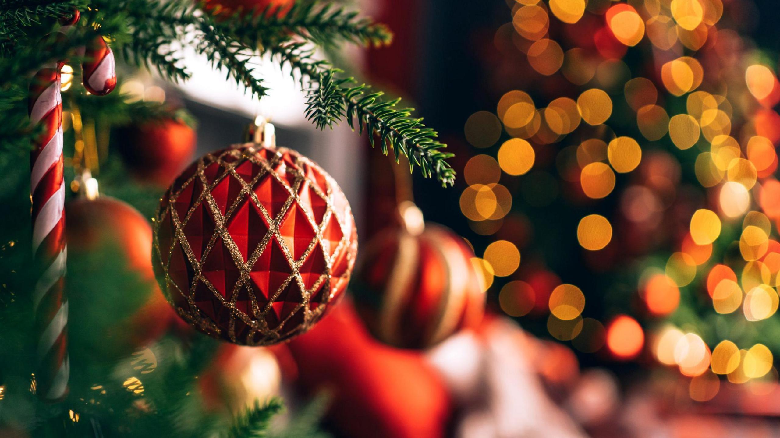 Christmas tree baubles and lights on a Christmas tree.