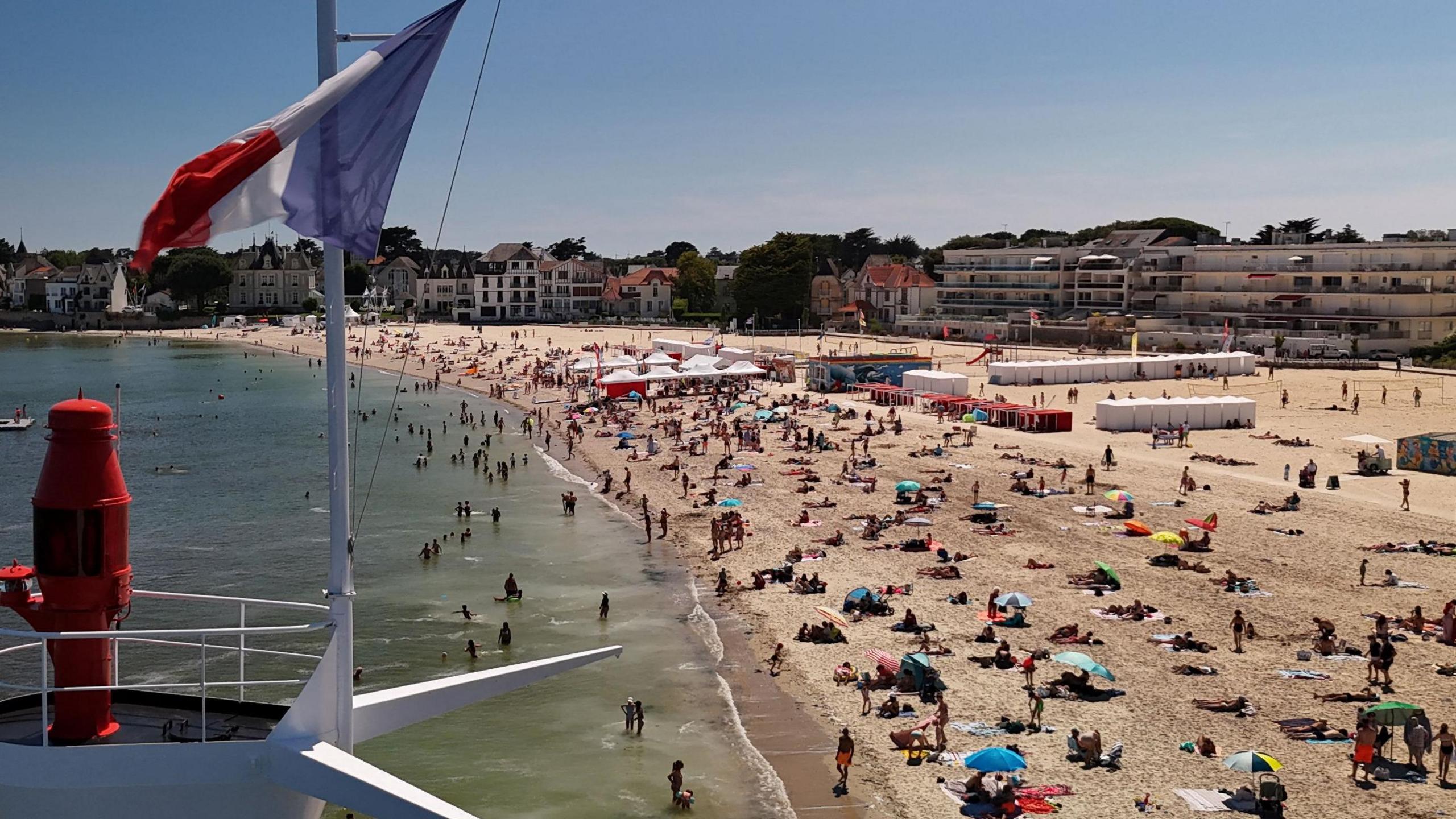 Drone view of the French west coast beach of Le Pouliguen showing people on the sand and in the water