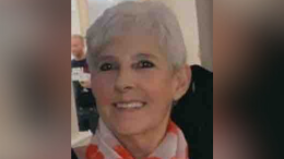 Image of Marie Casey. She is 63, with short grey hair. She is smiling and wearing a scarf.