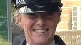 PC Prior, a blonde woman, smiles at the camera in uniform