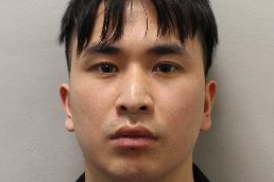 Police mugshot of Zou, looking impassively at the camera