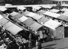 A black and white image of Hucknall Market taken from above. There are dozens of stalls and people milling about.