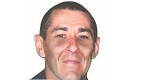 An artificially generated image showing missing David McCallum 22 years later. He has very short hair and has prominent cheekbones. He has angled eyebrows that are brown same as his hair. No facial hair.