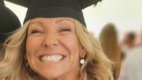 A picture of Claire smiling at the camera. She is wearing a black graduation cap and has blonde hair.