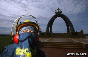 Worker in front of The Billionth Barrel of Oil Monument, Seria, Brunei