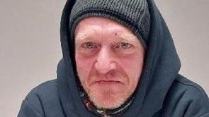 Matthew Weller wears a grey beanie hat under a dark hooded top.