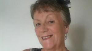 A smiling woman with short, grey hair. 