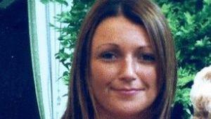 A picture of Claudia Lawrence smiling towards the camera with a green plant in the background.