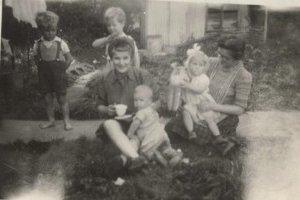 John Cosh and his family outside a Nissen hut