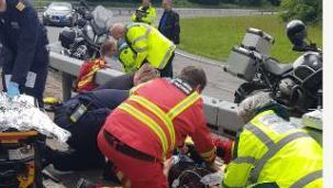 Paramedics work on the side of a road