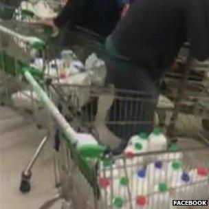 Farmers filling trolleys with milk