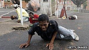 Demonstrators scatter in the face of gunfire in Madagascar