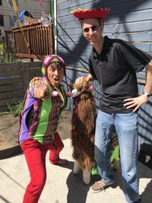 Befuddled SXSW participant Anthony Zurcher poses with a Peruvian and his stuffed llama.