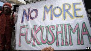 A demonstrator holds a "No more Fukushima" sign during a rally against restarting the Ohi nuclear power plant reactors in front of the prime minister's official residence in Tokyo, on 16 June 2012