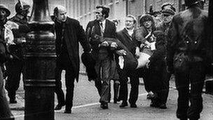 People carrying body of injured man on Bloody Sunday