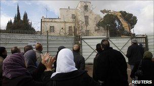 Palestinians watch as the Hotel Shepherd is torn down, East Jerusalem (9 Jan 2011)