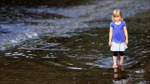 girl walking by stream