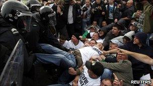 Riot police remove protesters