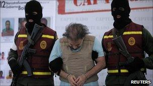 Colombian Carlos Alberto "Beto" Renteria is escorted handcuffed by Venezuelan secret police