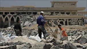 Palestinians collect gravel at the bombed Rafah airport, June 2010