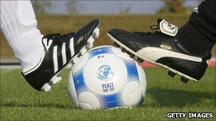 Adidas and Puma staff play football