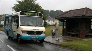 Elderly lady getting on bus