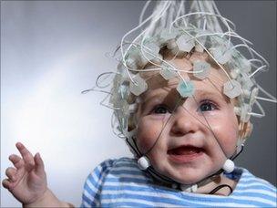 Baby wired up for EEG, BBC