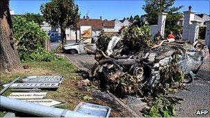 Torched cars and toppled street signs in Saint-Aignan, central France, 18 Jul 10