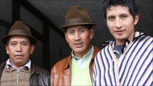 Ricardo Chaluisa, left, president of the La Cocha community, together with other members