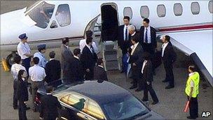 Officials wait by Ms Kim's plane at Haneda airport