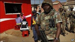 South African soldiers patrol the Diepsloot township north of Johannesburg, South Africa, Friday July 9 2010
