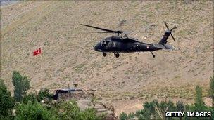 A helicopter from the Turkish security forces hovers a hill in Hakkari province, southeastern Turkey