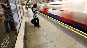 A passenger waits on a Tube platform