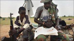 Jem rebel fighters studying before heading out on patrol - photographed at a base on 9 September 2004