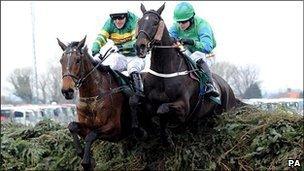 Don't Push It and Black Apalachi jump the last fence at the Grand National