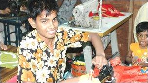 young male working at a sewing machine
