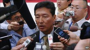 North Korean spokesman Ri Tong-il, centre, surrounded by journalists in Hanoi, Vietnam, 22 July 2010