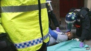 Ian Tomlinson being given treatment after collapsing at the G20