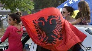 Kosovo Albanians celebrate the ruling in the divided city of Mitrovica