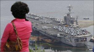 A woman looks at the USS George Washington in Busan in South Korea on 24 July, 2010