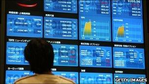 man looking at stock exchange board