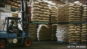 Sacks in a warehouse being moved by a forklift truck
