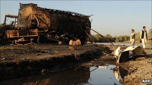 Afghan civilians inspect airstrike wreckage, Kunduz, September 2009