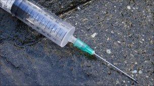 Needle on pavement