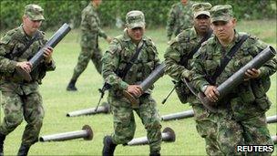 Colombian soldiers carry mortars seized in Cali said to belong to Farc rebels